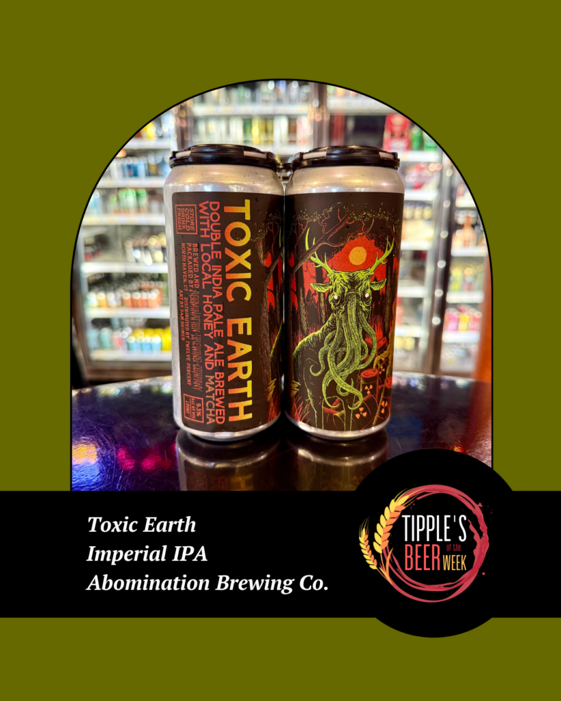 Promotional image for Tipple’s Beer of the Week featuring two tall cans of “Toxic Earth” Imperial IPA by Abomination Brewing Company displayed on a glossy counter in front of a refrigerated beer case inside a store. The cans show dark, detailed artwork with a surreal, tentacled deer-like creature against a red sun and forest background. The design uses an olive-green background with a circular photo frame and a black banner at the bottom. White text reads: “Toxic Earth, Imperial IPA, Abomination Brewing Co.” The Tipple’s Beer of the Week logo appears on the right side of the banner. The overall tone is bold and edgy, highlighting a high-impact craft beer selection.